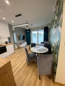 a living room with a table and chairs at Apartamenty Białe nad jeziorem Białym in Augustów +229 photos