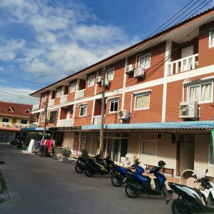 una fila de motocicletas estacionadas frente a un edificio en Haadrin village Fullmoon, en Haad Rin