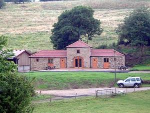 a car parked in front of a large house at Wykham in Nettleton