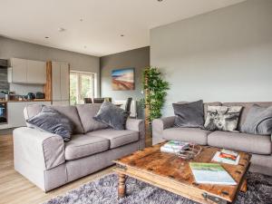 a living room with a couch and a coffee table at Three The Old Stables in Knitsley