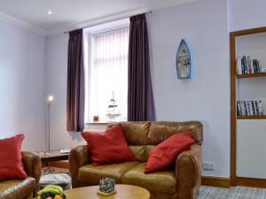 a living room with a couch and a table at The Boathouse in Findochty