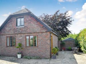 a brick house with a patio in front of it at Coastal Retreat in Felpham