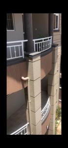 a building with balconies on the side of it at Brooks apartments in Kampala