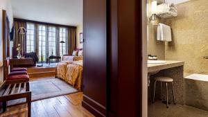 Cama ou camas em um quarto em Pousada Mosteiro de Guimaraes