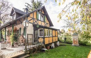 a yellow and white house with a yard at Stunning Home In Knringue With Sauna And 1 Bedrooms in Knoeringue