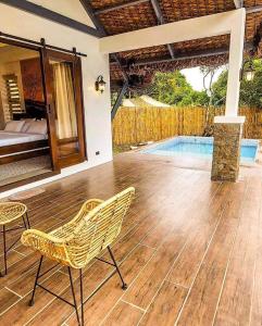 a patio with a chair and a swimming pool at White Hut Villas by Asog resort in Naga