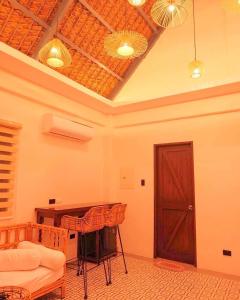 a room with a table and a wooden door at White Hut Villas by Asog resort in Naga