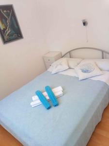 a bed with two blue and white towels on it at Apartments in Kraljevica 33251 in Kraljevica