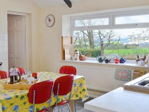a dining room with a table and a window at Glendale Cottage in Haltwhistle