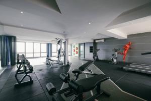a gym with several treadmills and machines in a room at Dorsett Hartamas KL with BathTub near MITEC MontKiara Publika in Kuala Lumpur