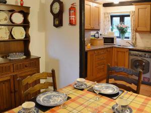 a kitchen with a table with plates on it at Bradley House in Harrop Fold