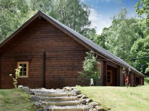 a log cabin with stairs leading up to it at Alder - Uk5502 in Killin