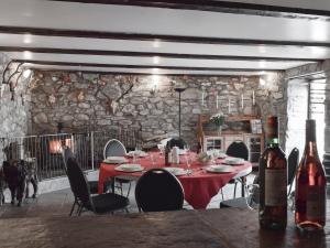 a dining room with a red table and chairs and a dog at Alder - Uk5502 in Killin