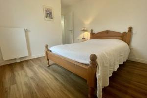 a bedroom with a large bed with a wooden floor at Nice 66m with terrace in La Rochelle in La Rochelle