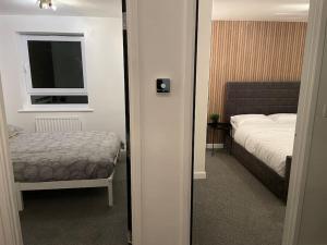 a small bedroom with a bed and a window at Stunning Central Apartment With Free Parking in Sheffield