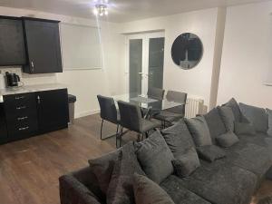 a living room with a couch and a table at Stunning Central Apartment With Free Parking in Sheffield