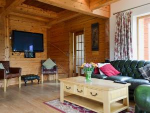 a living room with a couch and a tv at Gairlochy Bay in Gairlochy