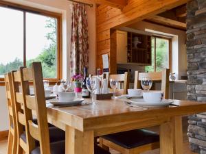 a wooden table with chairs and a dining room at Gairlochy Bay in Gairlochy
