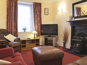 a living room with a television and a fireplace at The Quay in Pembroke