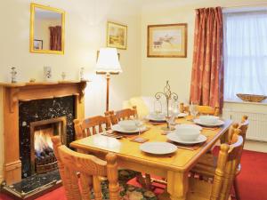 a dining room with a table and a fireplace at The Quay in Pembroke