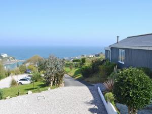 a road leading to a house with the ocean in the background at The Gallery in Mevagissey