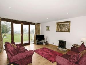 sala de estar con 2 sofás y chimenea en The Granary - E5483, en Froghall