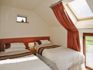 a bedroom with two beds and a window at The Granary - E5483 in Froghall