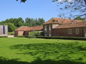 a large brick building with a large grass yard at The Stable - Ijx in Brigham