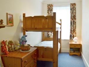 a bedroom with a bunk bed and a desk at Rosedene in Bembridge