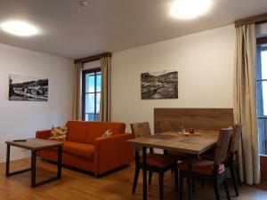 a living room with a couch and a table at Polanský Dvůr in Velké Karlovice