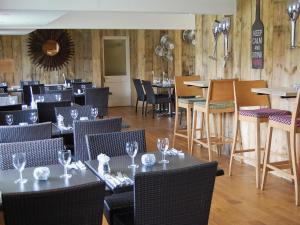 a restaurant with tables and chairs in a room at Stable Barn - 30954 in Thursford