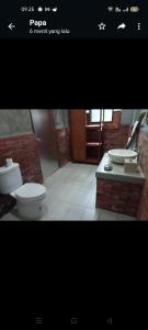 a picture of a bathroom with two sinks and a toilet at Araya villa saba in Saba