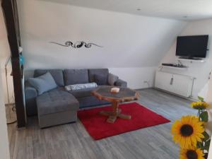 a living room with a couch and a table at Ferienwohnung Stuppi in Martinshöhe