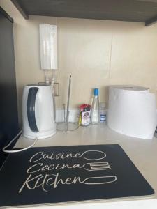 a kitchen counter with a sign on a counter top at A pasos de cavancha in Iquique
