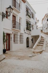 a white building with stairs in front of it at Casa Los Yayos by Nomad Stays in Altea