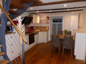 a kitchen and dining room with a table and chairs at Ferienwohnung Schindewolf in Grebenstein