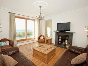 a living room with a couch and a coffee table at Glan Y Mor 1 in Trearddur
