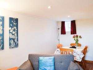 a living room with a couch and a table at The Hen Hoose in Creebridge