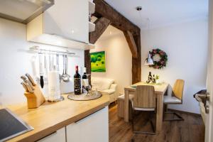 a kitchen with a table with wine bottles on it at Altstadtjuwel @Conny's in Brilon