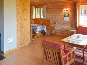 a living room with a table and a piano at Holiday home olden X in Olden