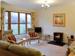 a living room with a couch and a fireplace at Taigh Seonaig in Glencoe