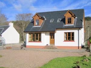 a white house with a black roof at Taigh Seonaig in Glencoe