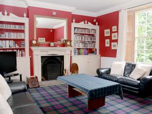 a living room with a couch and a fireplace at Abbotts Farm in Horbling