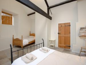 a white room with a bed and a bedroom at The Old Forge in Kingston