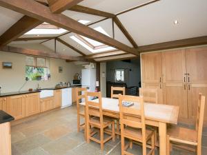 a kitchen with a wooden table and wooden cabinets at The Old Forge in Kingston