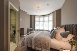 a bedroom with a bed and a window at Modern Two Bed with En-Suites and Private Parking in Cardiff