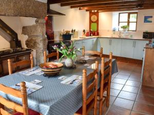 a kitchen with a table with a bowl of fruit on it at Bruces Cottage in Saint Erth