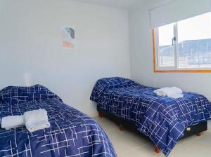 a bedroom with two beds and a window at primitivo complejo in Comandante Luis Piedra Buena