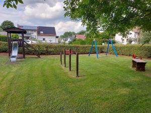 a park with playground equipment in the grass at Ferienhaus Hinrichs 