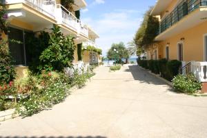a walkway between two buildings in a resort at Lemon Grove Hotels And Studios in Kavos +17 photos